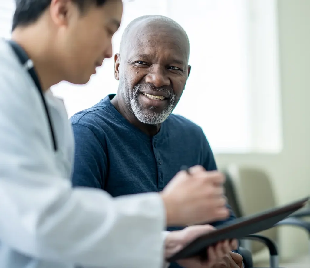 Photo of doctor and older man discussing results
