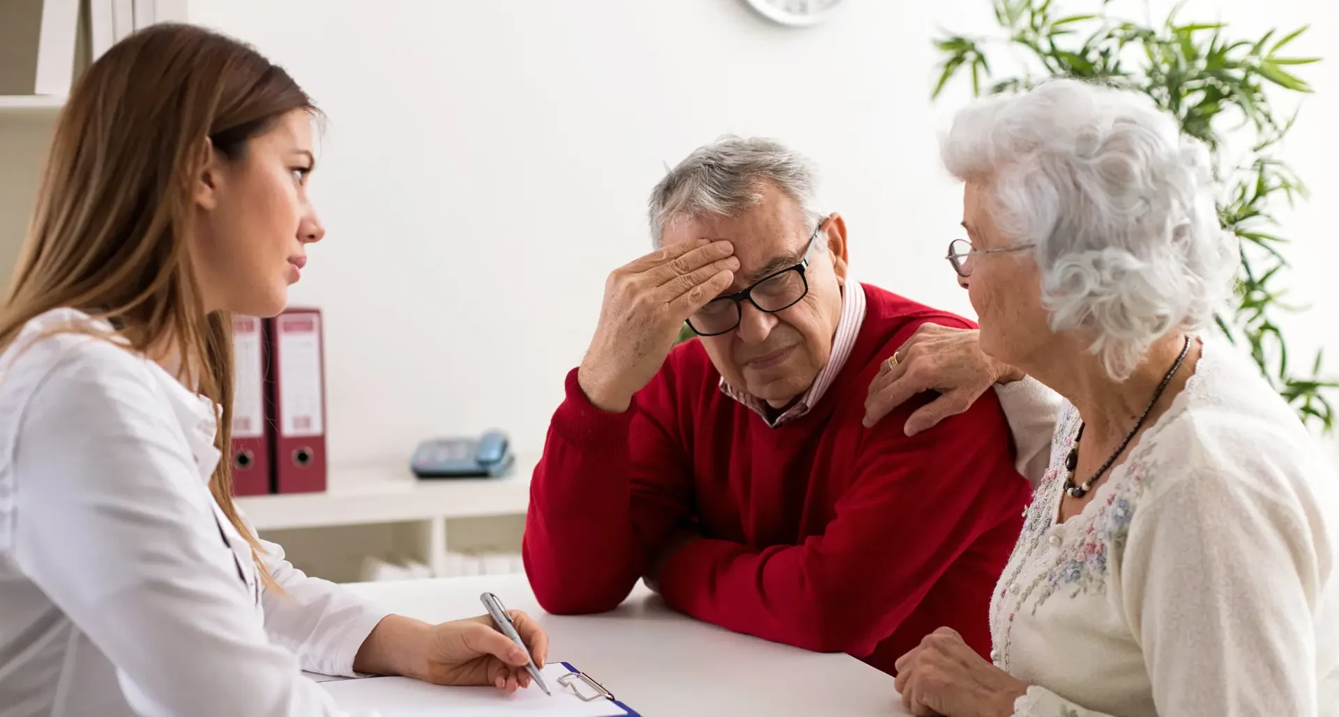 doctor discussing an Alzheimer's disease research study to a participant and their companion