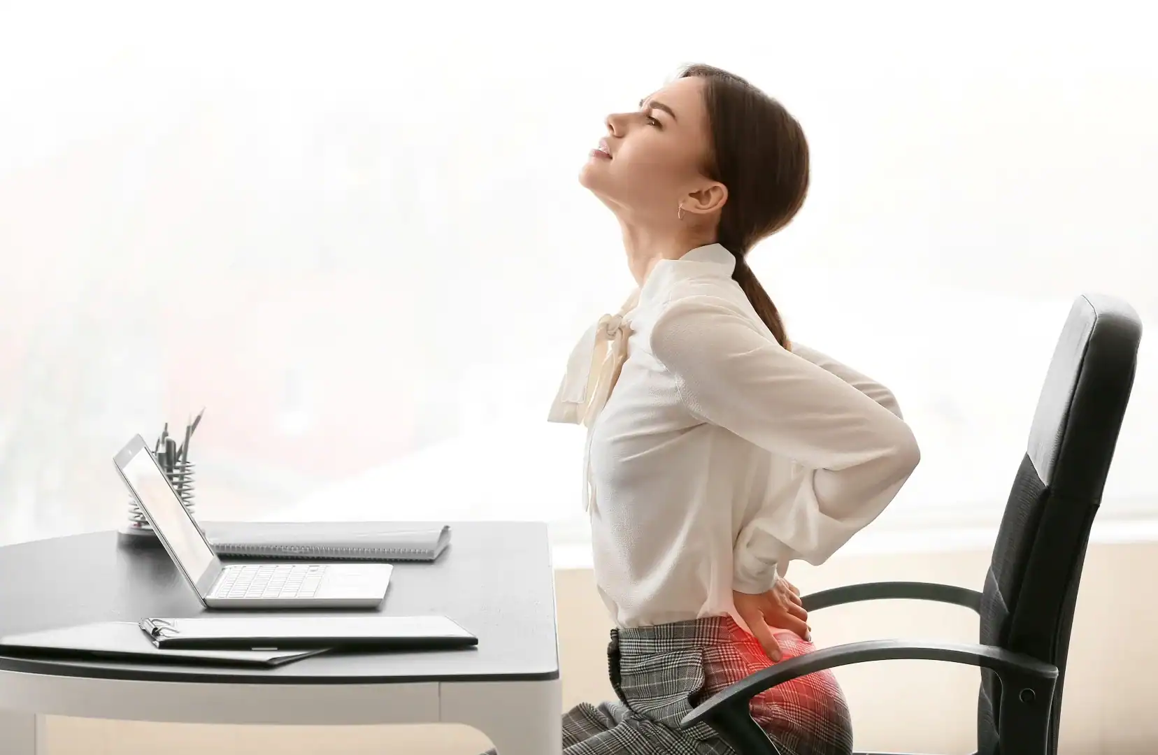 woman with symptoms who may qualify for a lower back pain research study